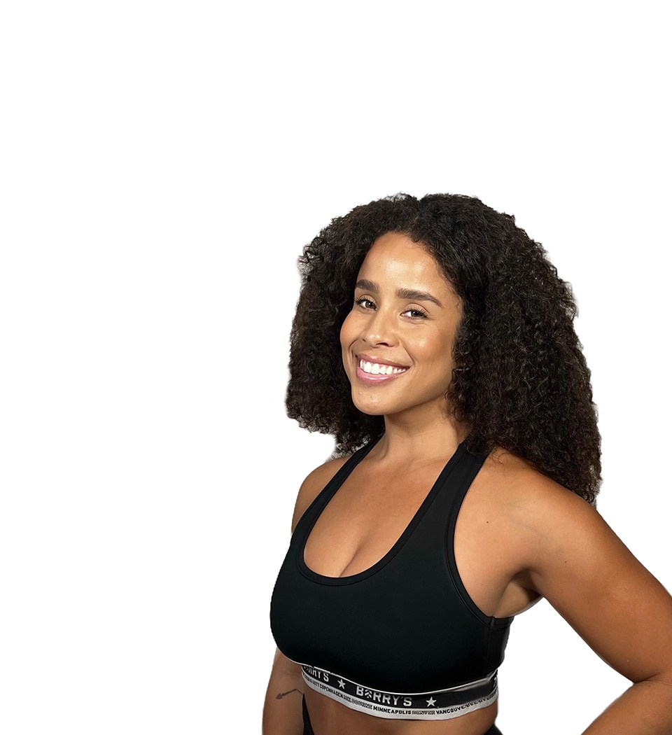 Barry's instructor standing confidently wearing a black top against a white background.