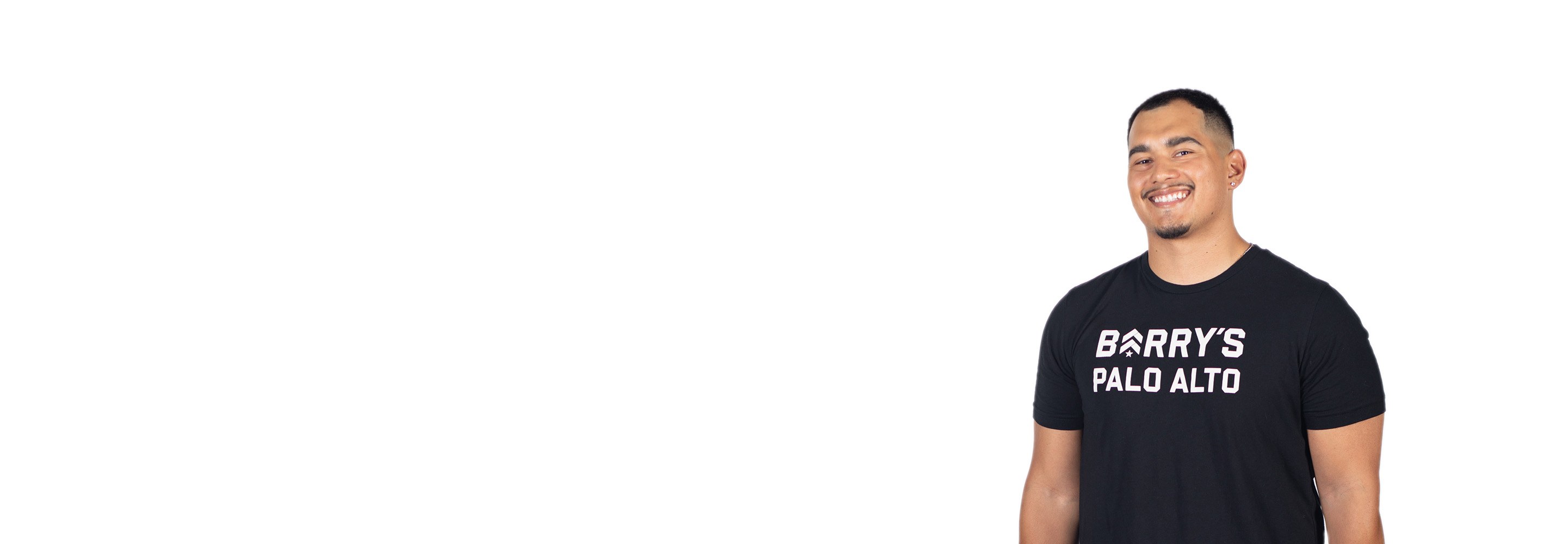 Barry's instructor standing confidently wearing a black top against a white background.