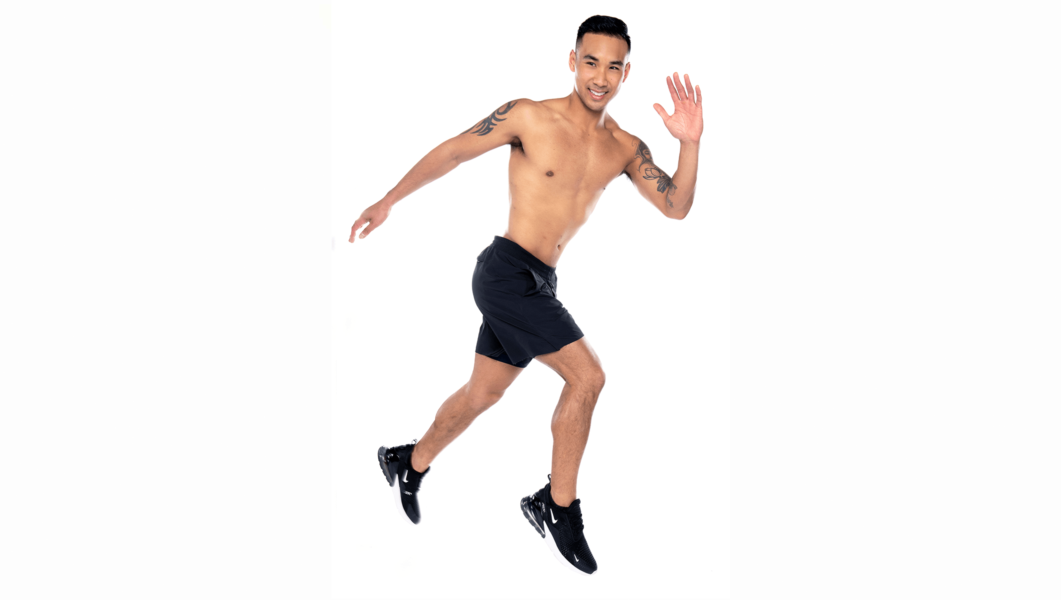 Barry's instructor running, wearing a black tank top against a white background, ready for the next workout challenge.