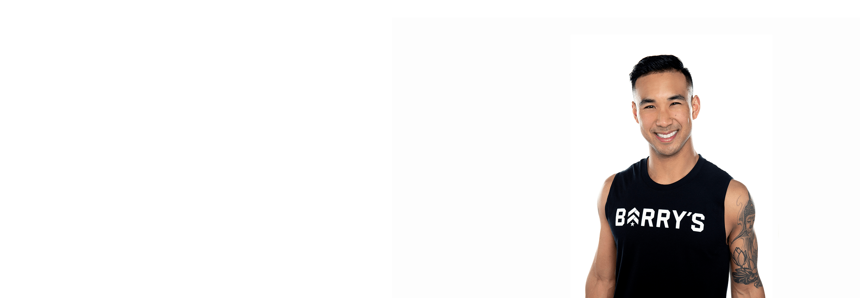 Barry's instructor standing confidently, wearing a black tank top against a white background, ready for the next workout challenge.