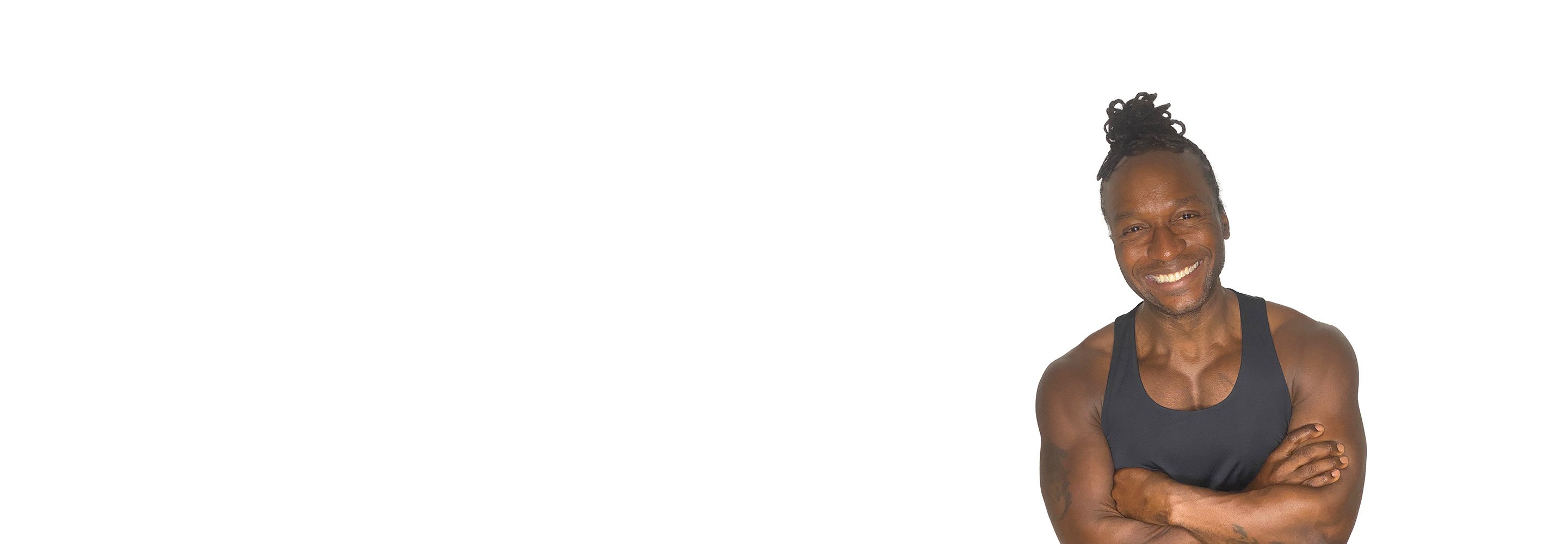 Barry’s instructor wearing a black top standing confidently smiling against a white background