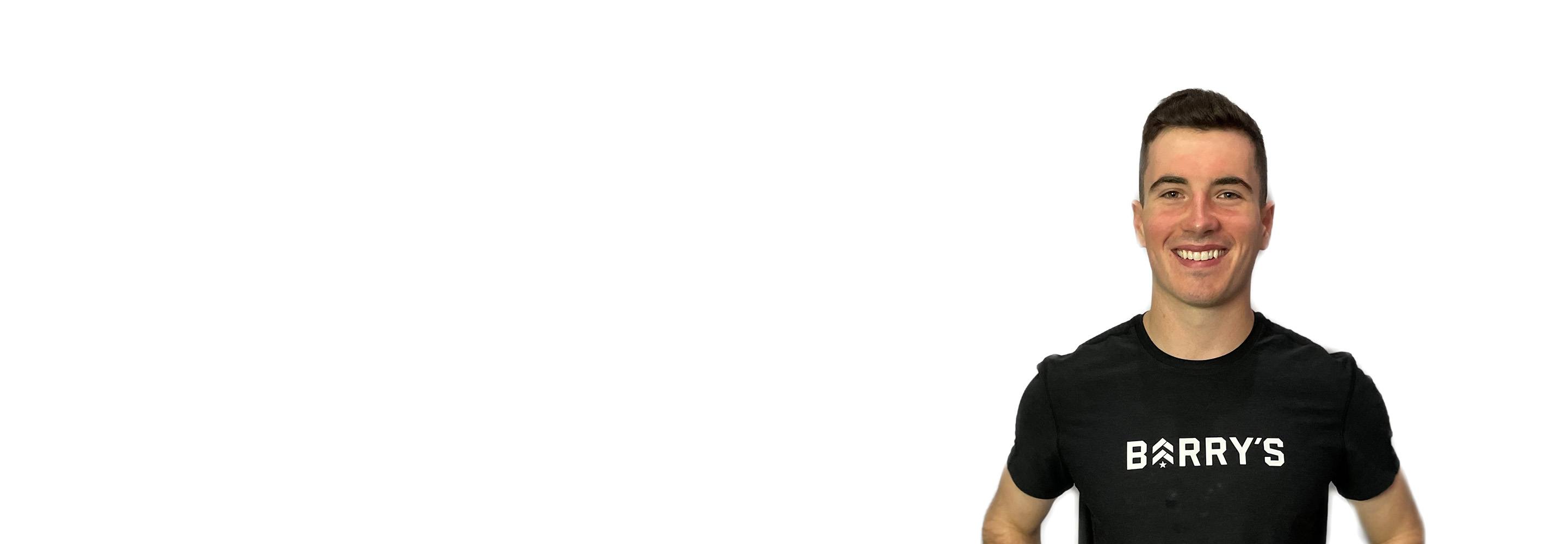 Barry's instructor standing confidently wearing a black top against a white background.