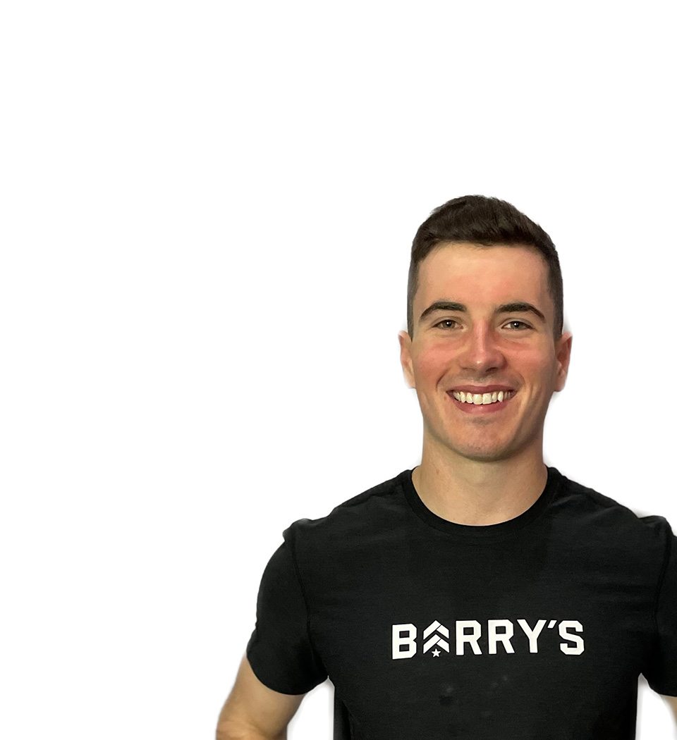 Barry's instructor standing confidently wearing a black top against a white background.