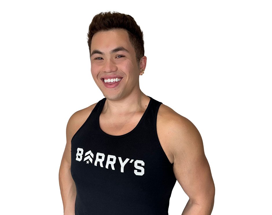 Barry's instructor standing confidently wearing a black top against a white background.