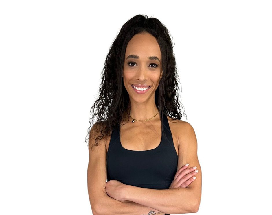 Barry's instructor standing confidently with arms crossed wearing a black top against a white background.