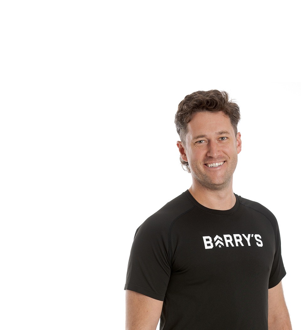 Barry's instructor standing confidently wearing a black top against a white background.