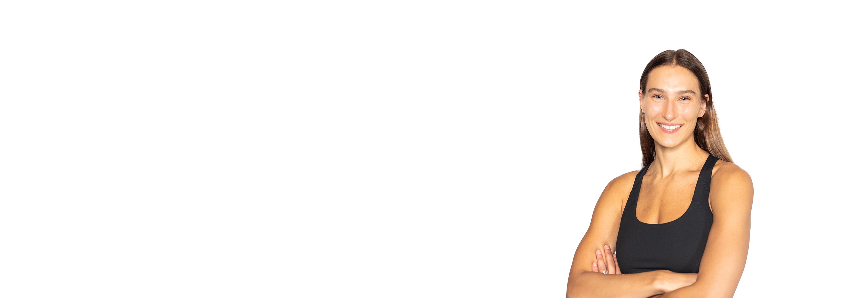 Barry’s instructor wearing a black top standing confidently smiling against a white background