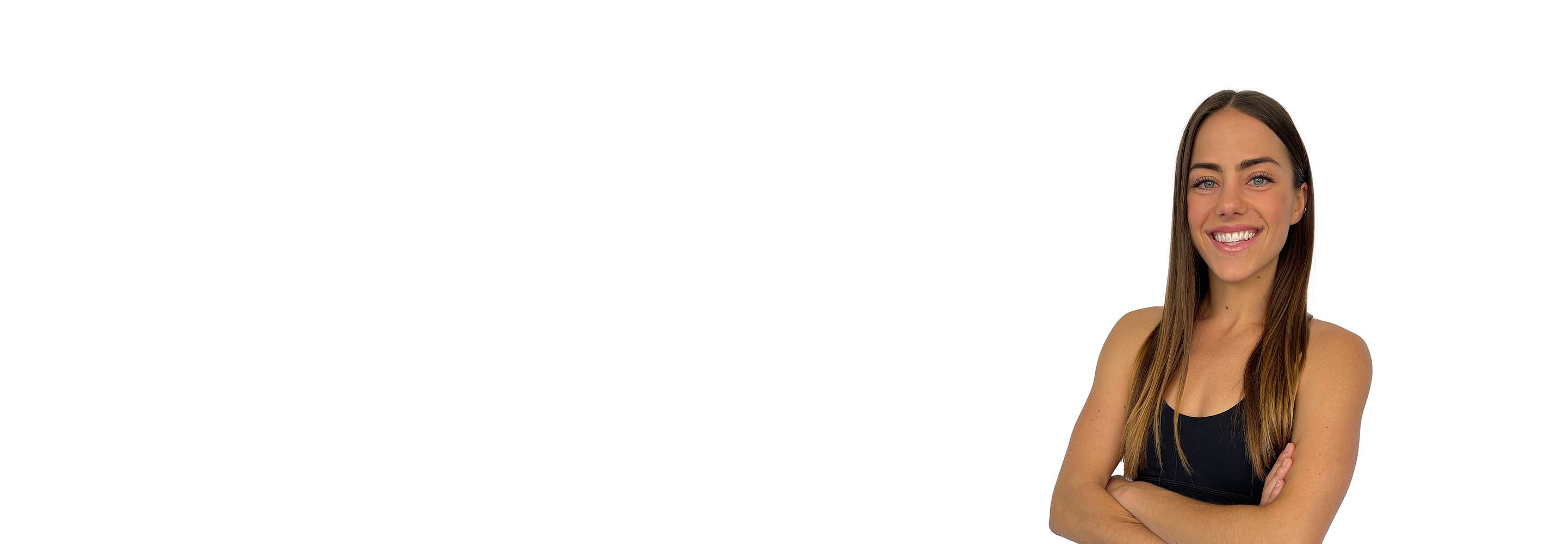 Barry's instructor standing confidently with arms crossed wearing a black top against a white background.