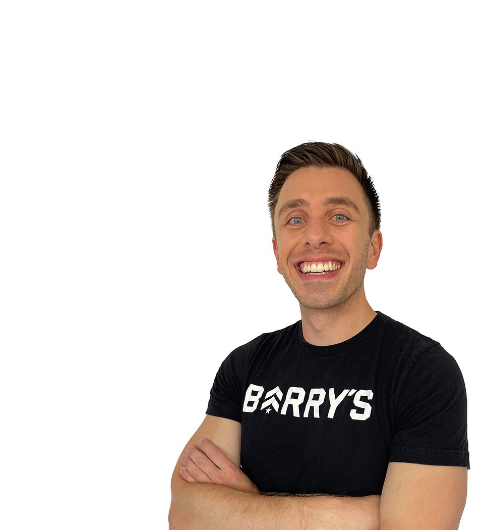 Barry's instructor standing confidently wearing a black top against a white background.