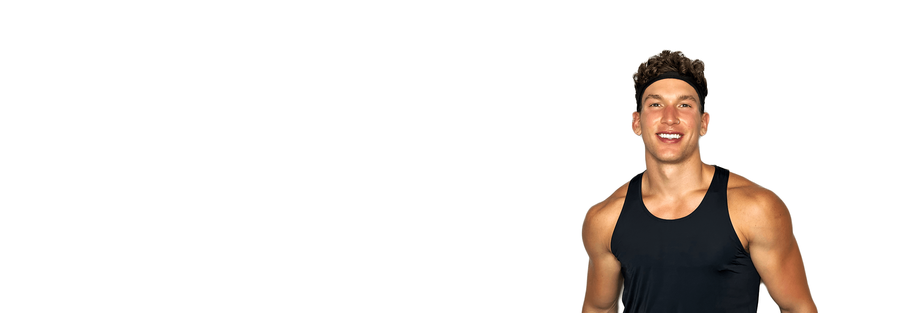 Barry’s instructor wearing a black top standing confidently smiling against a white background