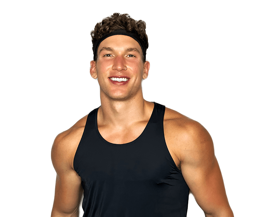 Barry’s instructor wearing a black top standing confidently smiling against a white background