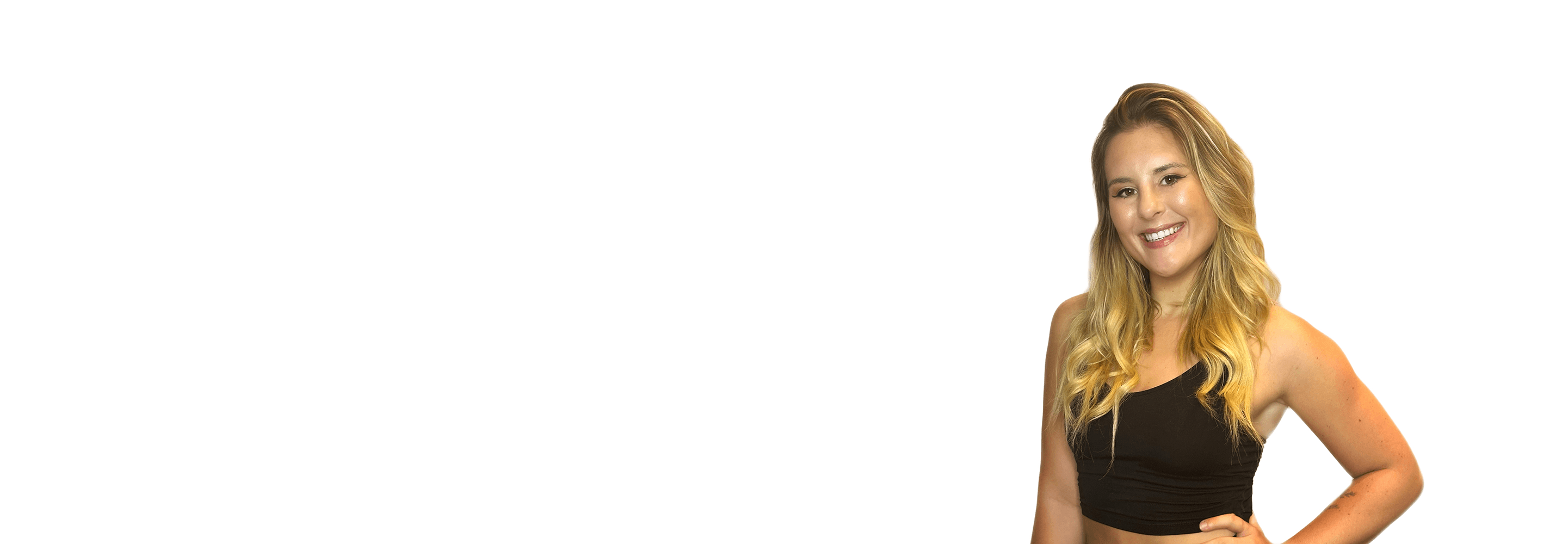 Barry’s instructor wearing a black top standing confidently smiling against a white background