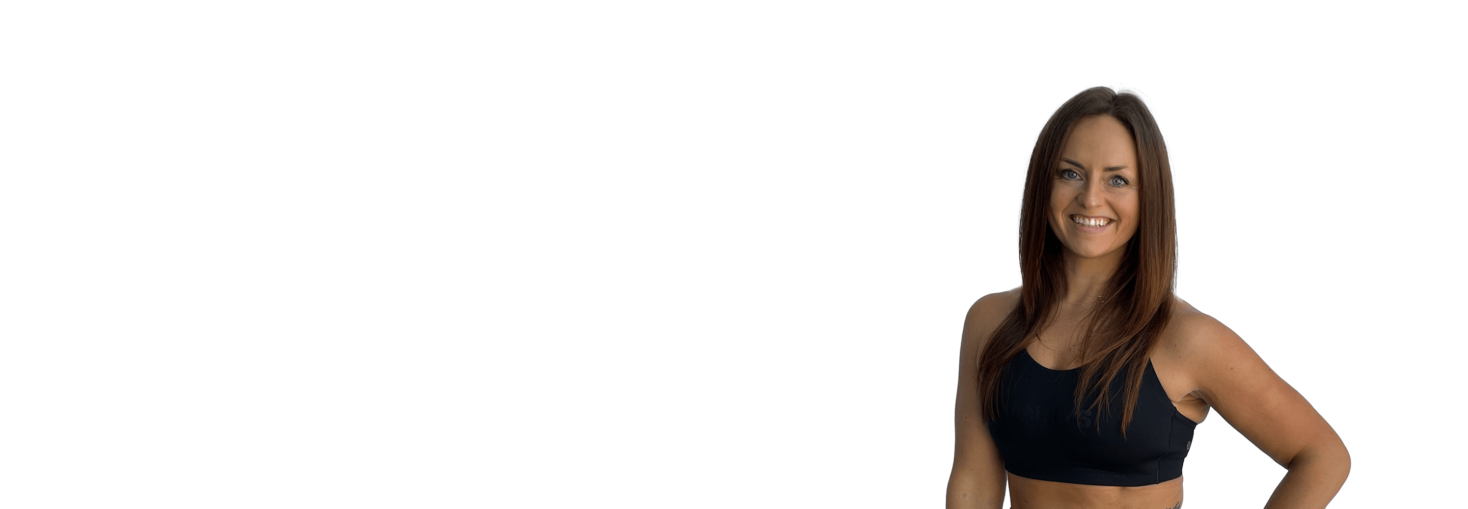 Barry’s instructor wearing a black top standing confidently smiling against a white background