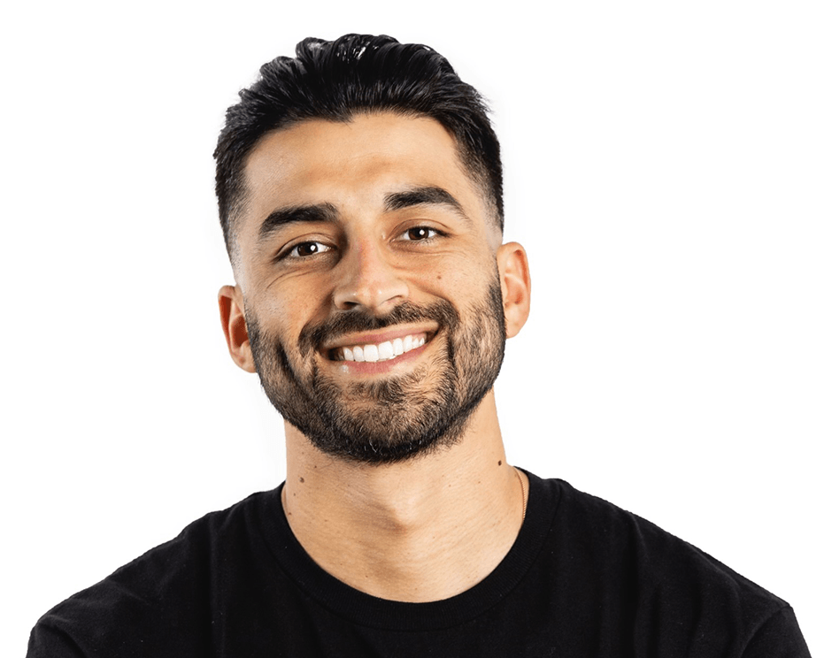 Barry’s instructor wearing a black top standing confidently smiling against a white background