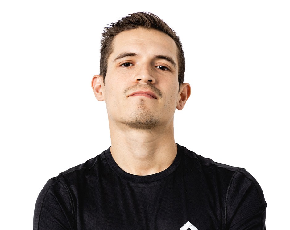 Barry’s instructor wearing a black top standing confidently smiling against a white background