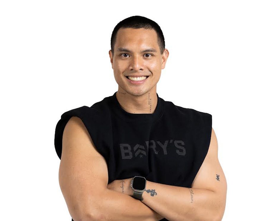 Barry's instructor standing confidently wearing a black top against a white background.