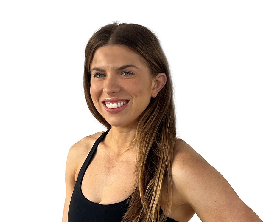 Barry's instructor standing confidently, wearing a black tank top against a white background, ready for the next workout challenge.