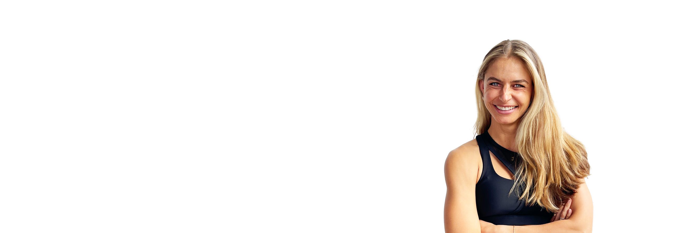 Barry's instructor standing confidently with arms crossed wearing a black top against a white background.