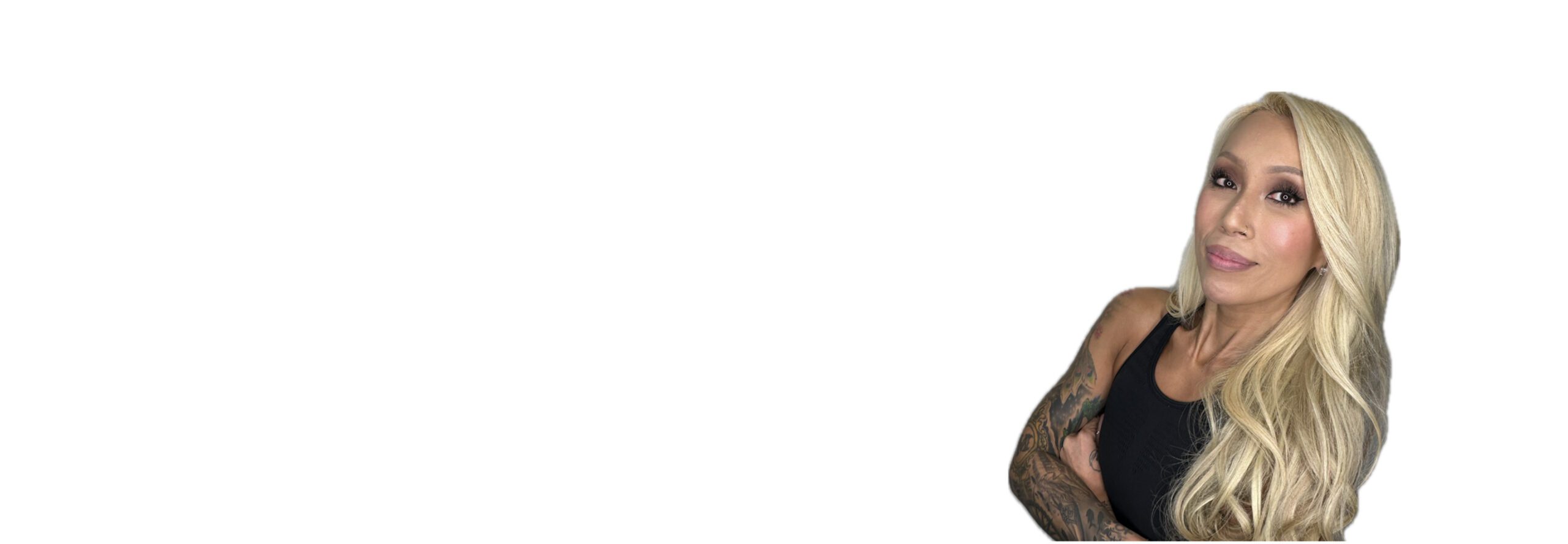 Barry’s instructor wearing a black top standing confidently smiling against a white background