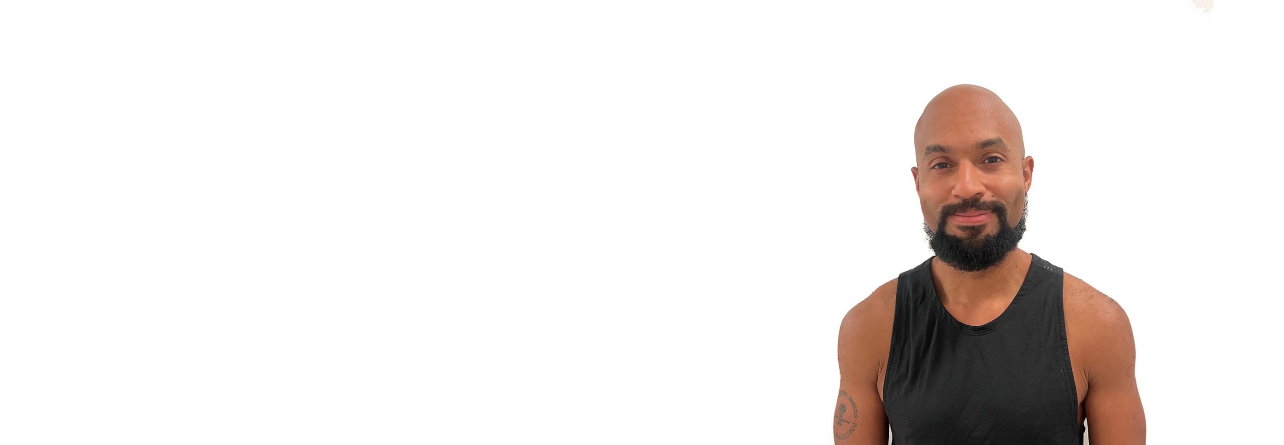 Adrian B. Barry's instructor standing confidently wearing a black top against a white background.