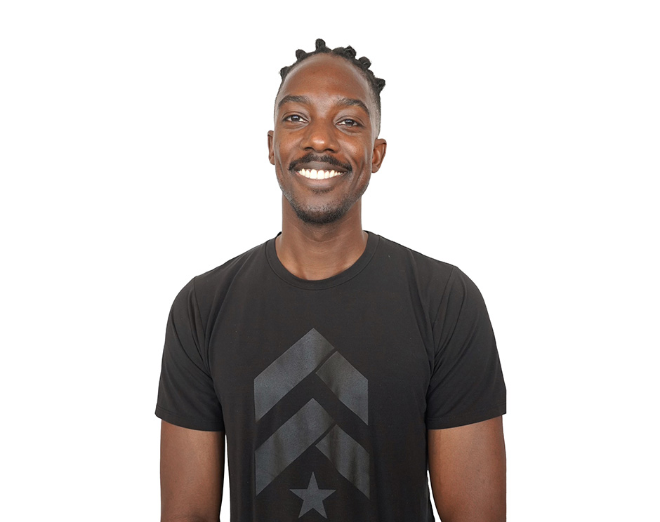 Barry's instructor standing confidently, wearing a black tank top against a white background, ready for the next workout challenge.