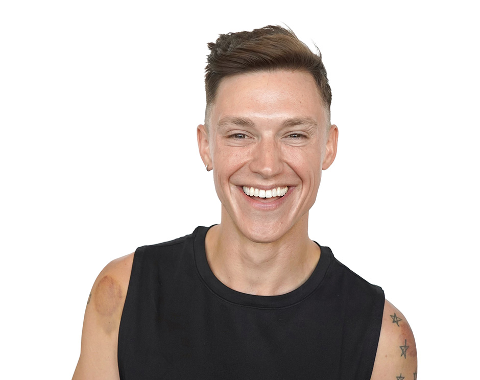 Barry's instructor standing confidently, wearing a black tank top against a white background, ready for the next workout challenge.