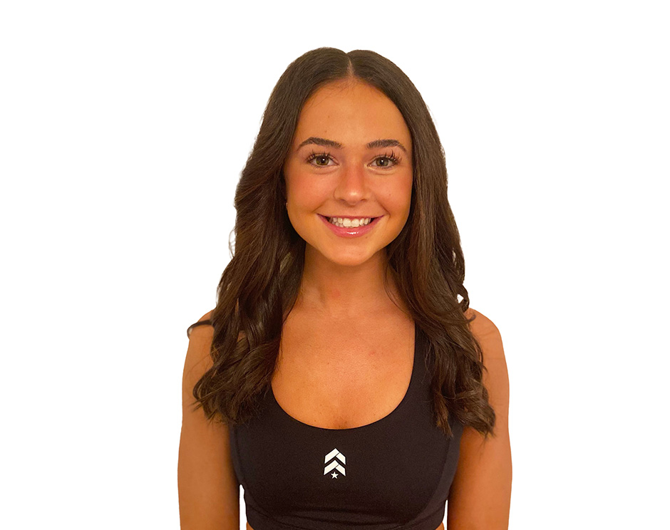 Kiley C. Barry's instructor standing confidently wearing a black top against a white background.