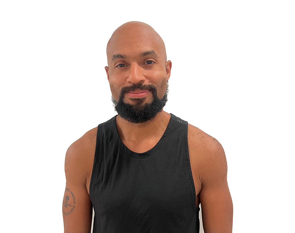 Adrian B. Barry's instructor standing confidently wearing a black top against a white background.