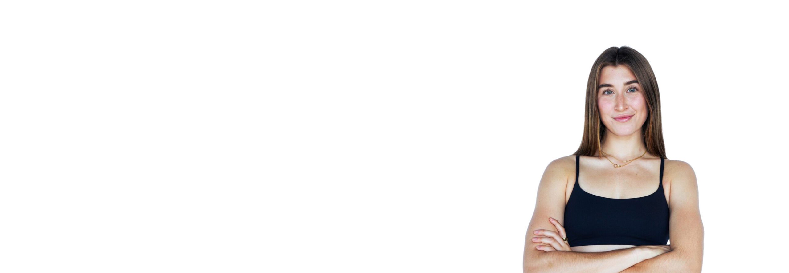 Barry’s instructor wearing a black top standing confidently smiling against a white background