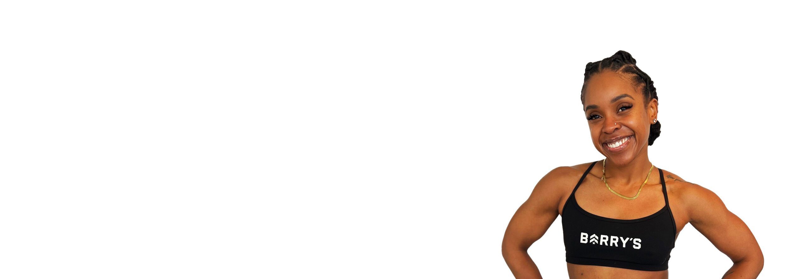 Barry's instructor standing confidently wearing a black top against a white background.