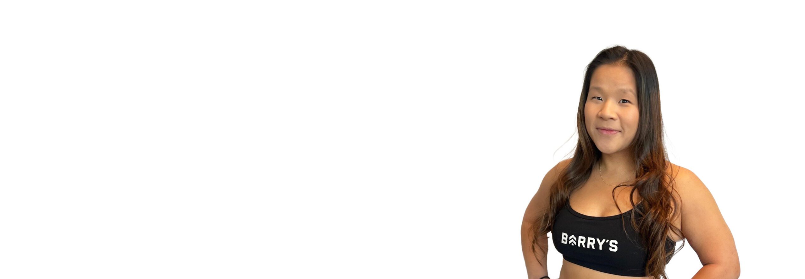 Barry's instructor standing confidently wearing a black top against a white background.