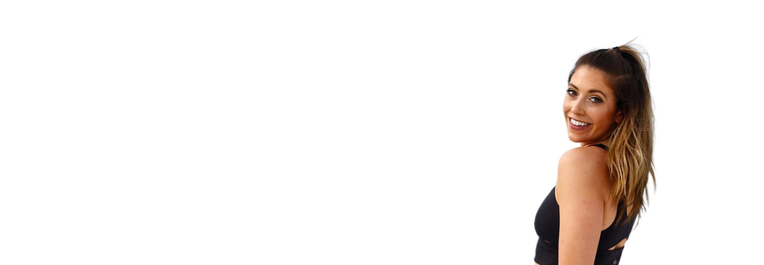 Barry's instructor standing confidently, wearing a black tank top against a white background, ready for the next workout challenge.