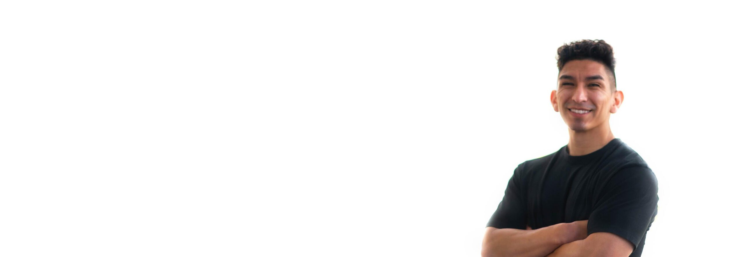 Barry's instructor standing confidently, wearing a black tank top against a white background, ready for the next workout challenge.