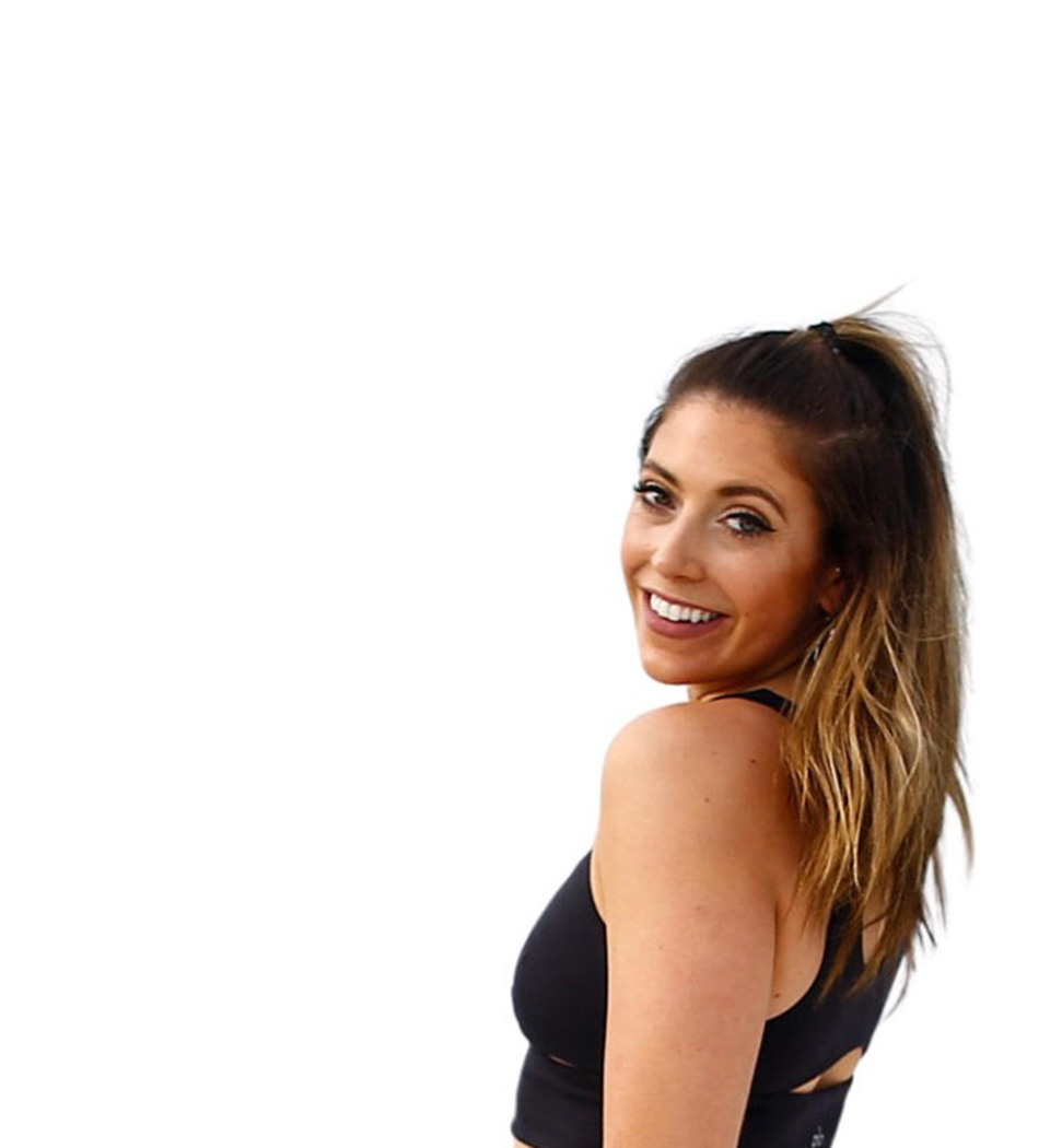 Barry's instructor standing confidently, wearing a black tank top against a white background, ready for the next workout challenge.