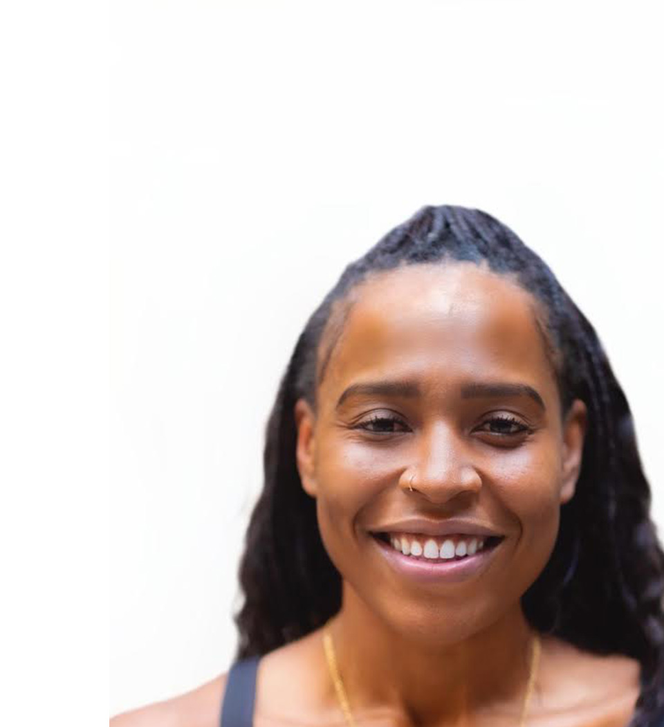 Barry's instructor standing confidently, wearing a black tank top against a white background, ready for the next workout challenge.