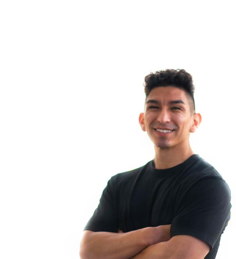 Barry's instructor standing confidently, wearing a black tank top against a white background, ready for the next workout challenge.