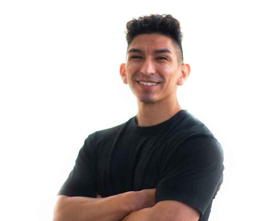 Barry's instructor standing confidently, wearing a black tank top against a white background, ready for the next workout challenge.