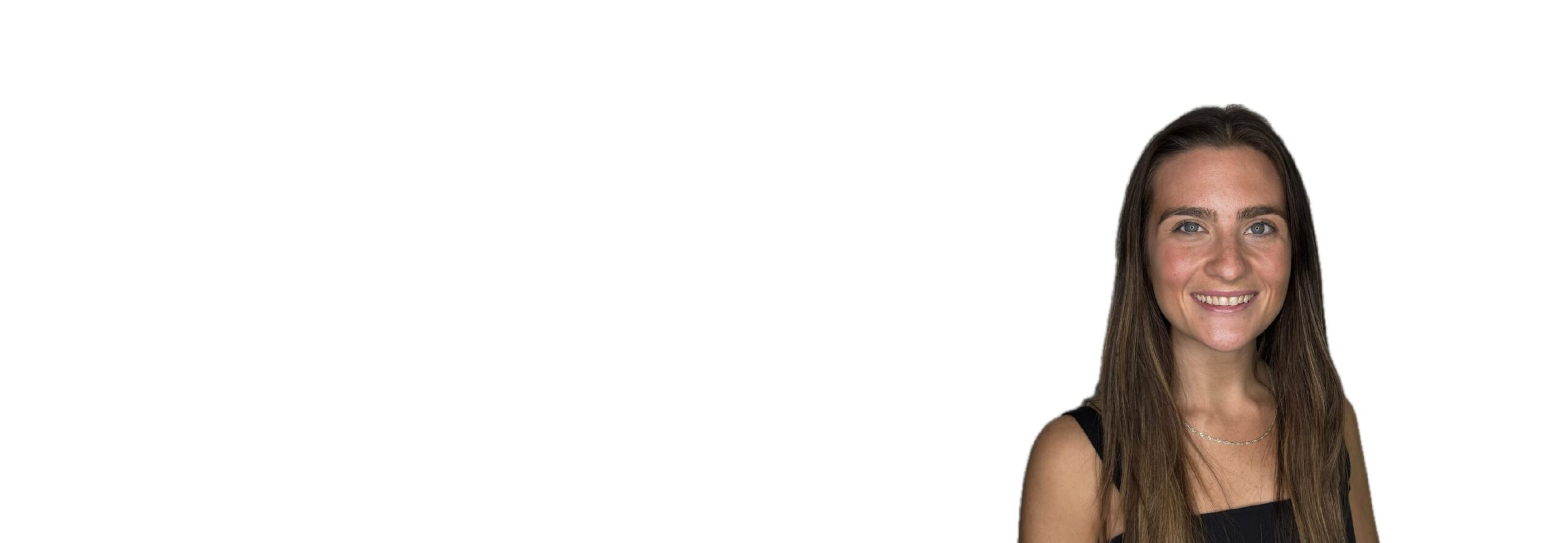 Barry’s instructor wearing a black top standing confidently smiling against a white background