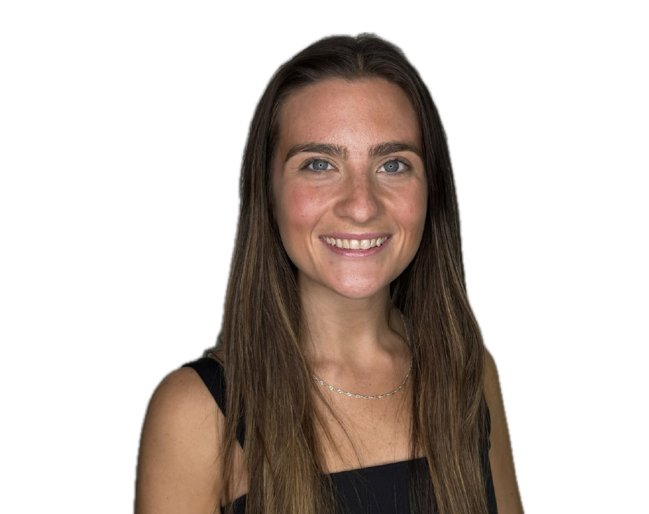 Barry’s instructor wearing a black top standing confidently smiling against a white background